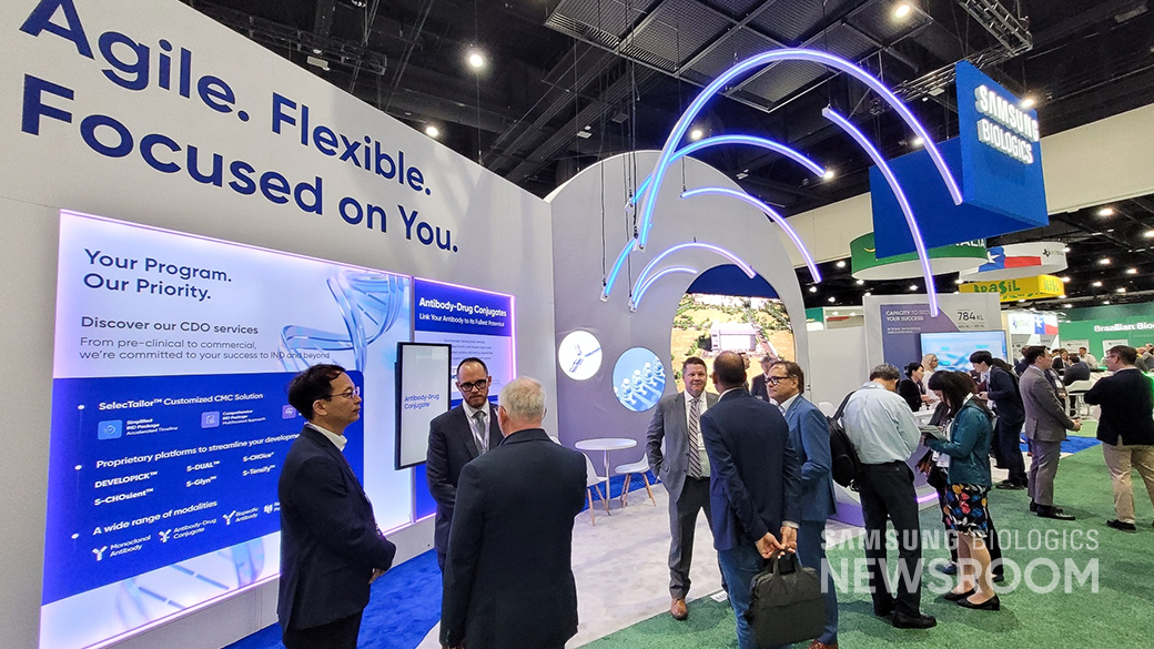 The Samsung Biologics team greets visitors at its booth